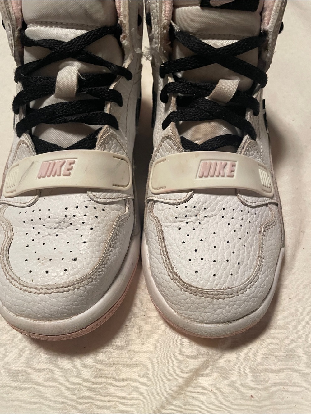Nike Girls White Air Jordans with Light Pink Accents. Lightweight and flexible
